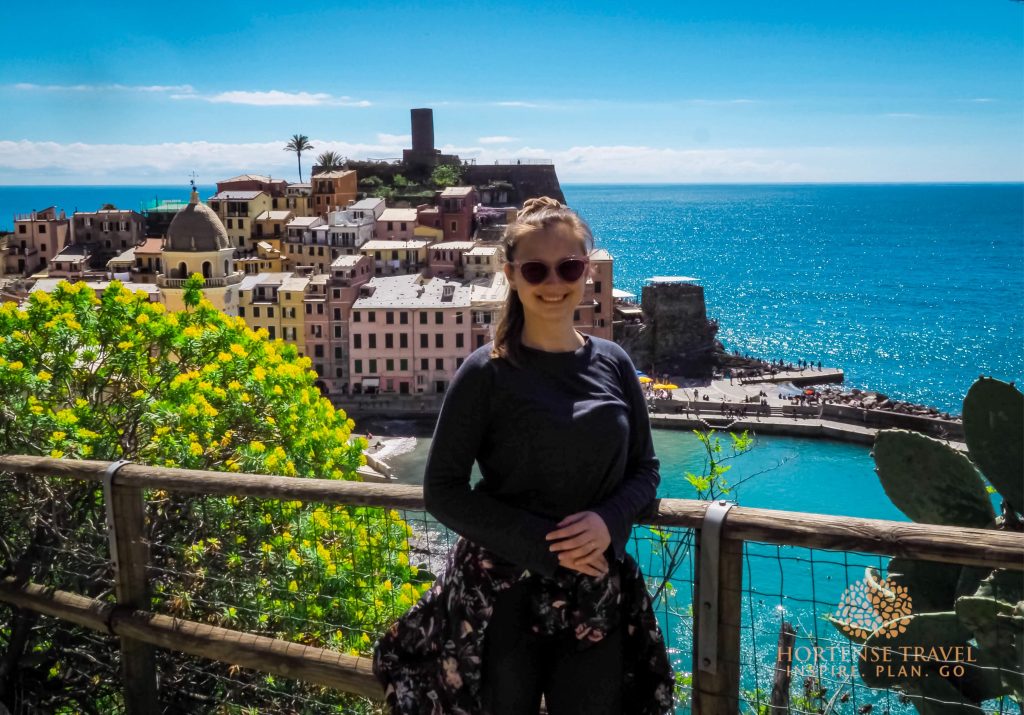 A girl posing in front of Vernazza village, Cinque Terre